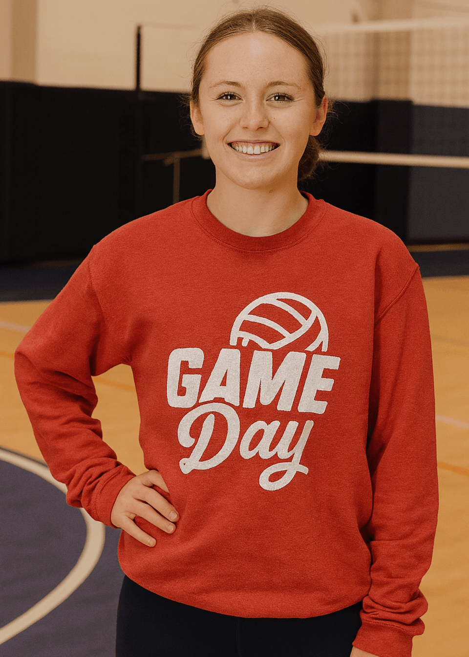 Person wearing a red 'Game Day' sweatshirt with a volleyball graphic on a basketball court.